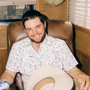 man sitting down wearing the diamond back shirt