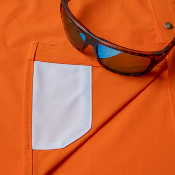 sunglasses with lens cleaner on shirt