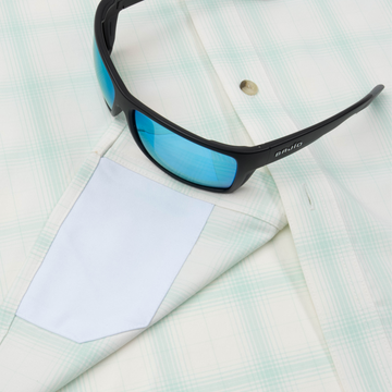 Closeup of sunglasses with lens cleaner on shirt
