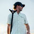 man holding pole wearing the drowned cays shirt