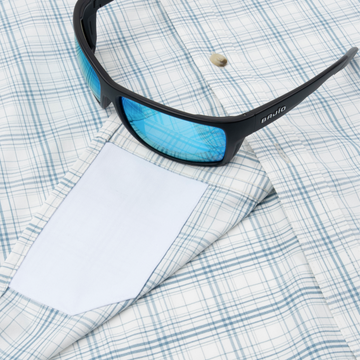 sunglasses with lens cleaner on shirt