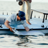 Man wearing "The End Game" shirt releasing large fish from a boat in calm water