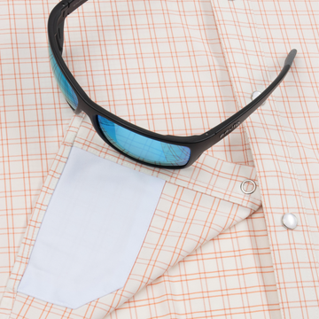 sunglasses with lens cleaner on shirt