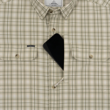 Phone in chest zipper pocket of shirt