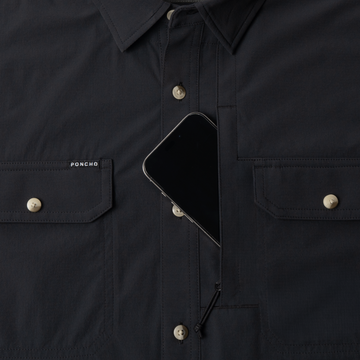 Phone in chest zipper pocket of shirt