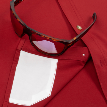 Closeup of sunglasses with lens cleaner on shirt