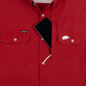 Phone in chest zipper pocket of shirt