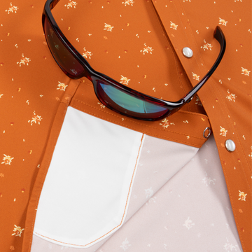 Closeup of sunglasses with lens cleaner on shirt