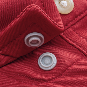 Close-up of red fabric with snap buttons on The Gamecock shirt
