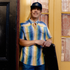 man in hat wearing the gris gris striped shirt