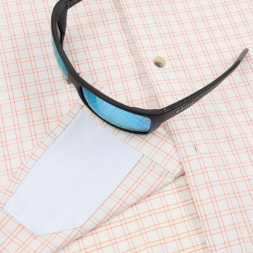 sunglasses with lens cleaner on shirt