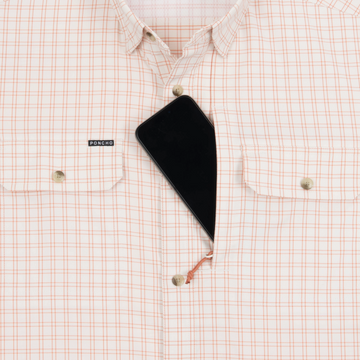 Phone in chest zipper pocket of shirt