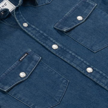 Close-up of The Harris denim shirt with pearl snap buttons and chest pockets by Poncho Outdoors