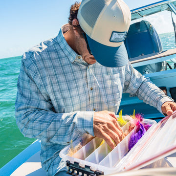 man with tackle box wearing the head shake shirt