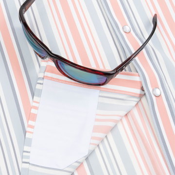 Closeup of sunglasses with lens cleaner on shirt