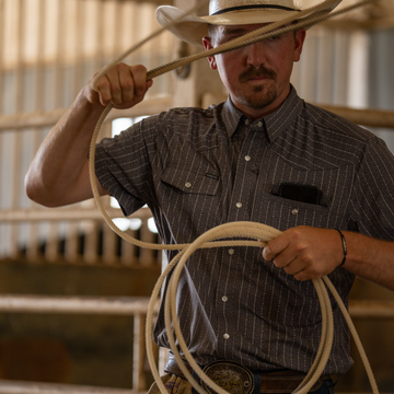 Cowboy holding a rope while wearing The Hondo