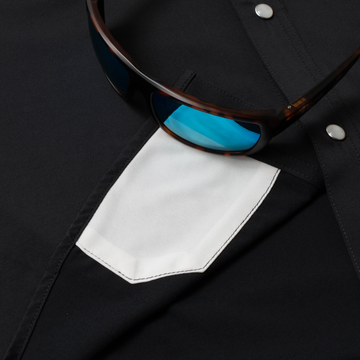 Close-up of black shirt pocket with blue-lens sunglasses on The Newt shirt