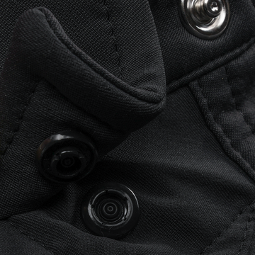 Close-up of black fabric with snap buttons on The Newt shirt