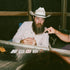 Man Playing cards while wearing the Jambalaya shirt