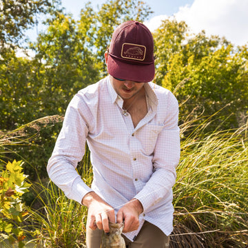 man with fish wearing the javelina mesh hat