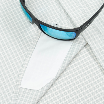 sunglasses with lens cleaner on shirt