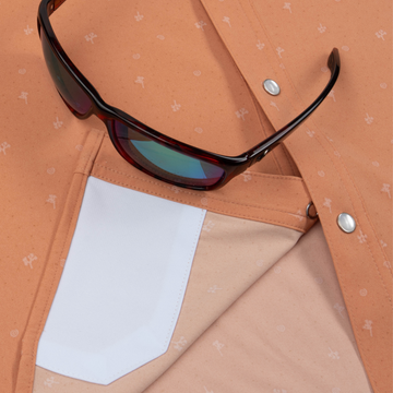 Closeup of sunglasses with lens cleaner on shirt