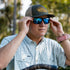 man putting on sunglasses