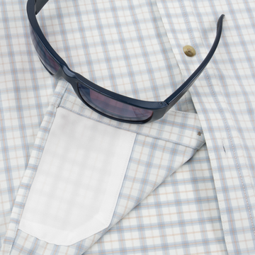 Closeup of sunglasses with lens cleaner on shirt