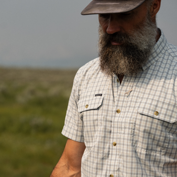 Bearded man wearing The Lamar Valley shirt outdoors in nature