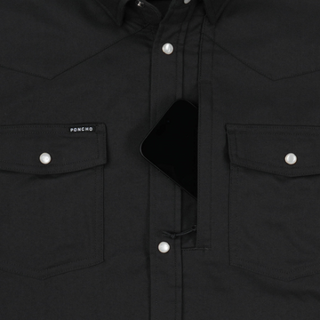 Close-up of black shirt pocket with phone and pearl buttons from The Laramie