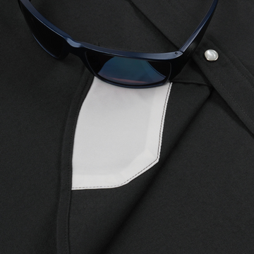 Close-up of The Laramie shirt pocket with sunglasses on black fabric