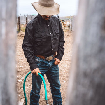 man wearing the laramie shirt with hose