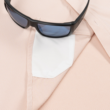 sunglasses with lens cleaner on shirt