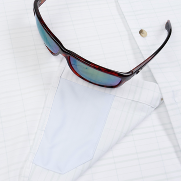 Closeup of sunglasses with lens cleaner on shirt
