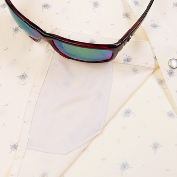 sunglasses with lens cleaner on shirt