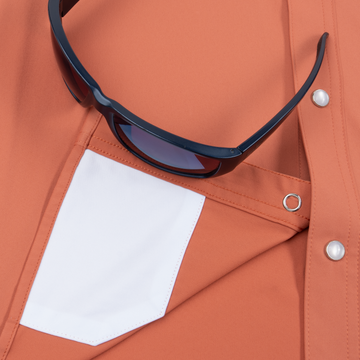 Closeup of sunglasses with lens cleaner on shirt