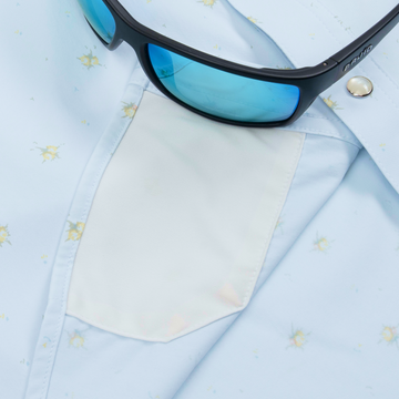 Closeup of sunglasses with lens cleaner on shirt