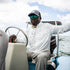 Man driving a boat while wearing The Marsh Harbour Shirt