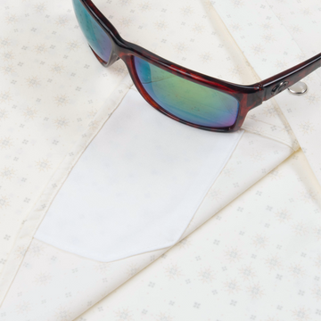 sunglasses with lens cleaner on shirt