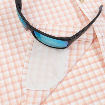 sunglasses with lens cleaner on shirt