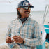 Man laughing while on a boat