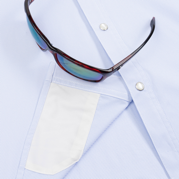 Closeup of sunglasses with lens cleaner on shirt