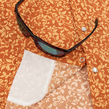 Closeup of sunglasses with lens cleaner on shirt