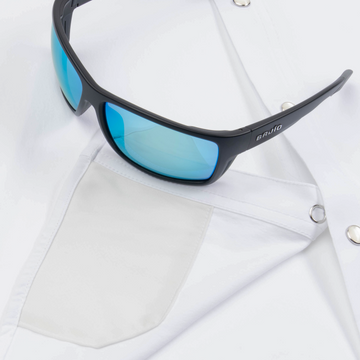 Closeup of sunglasses with lens cleaner on shirt