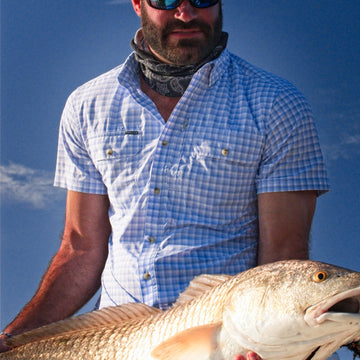 Man wearing the ono shirt holding fish