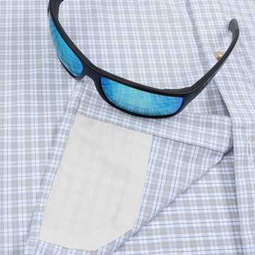 Closeup of sunglasses with lens cleaner on shirt