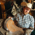 man with a saddle wearing the pagosa shirt