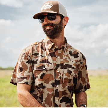 Man wearing The Paloma outdoors in camo shirt and sunglasses