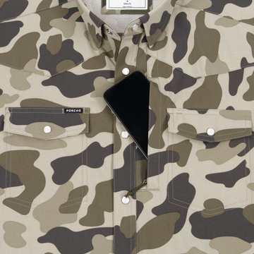 Close-up of The Pampa camouflage shirt with a hidden zippered pocket holding a smartphone