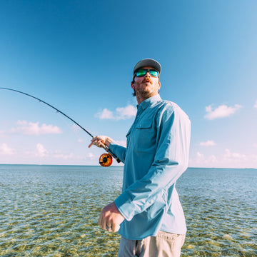 man with fly rod wearing the pennekamp shirt